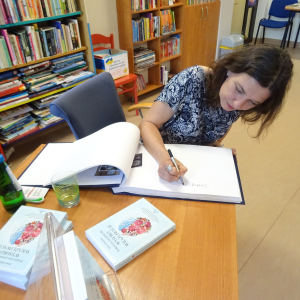 Beata Mąkolska wpisuje się do Księgi pamiątkowej.