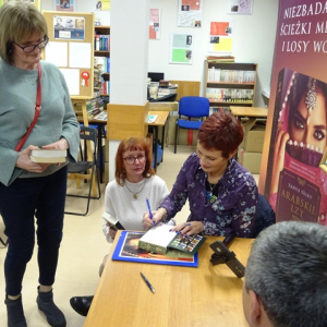 Tanya Valko wpisuje dedykację w książce 