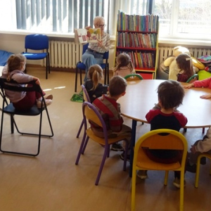 Bibliotekarka pokazuje dzieciom ilustracje